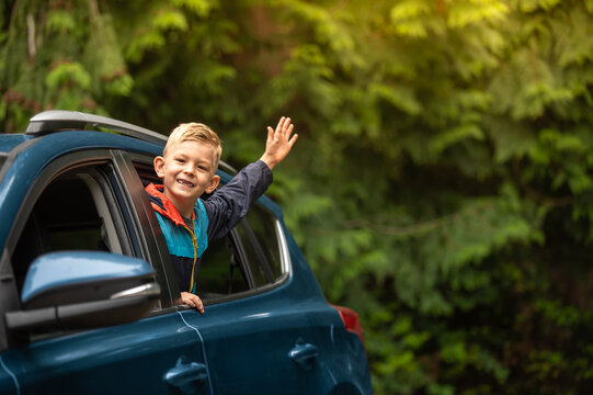 Portrait of happy little boy in car. Family road trip, summer holiday travel concept.	