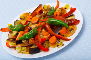 Image of plaque with vegetables in plate on the table indoor.