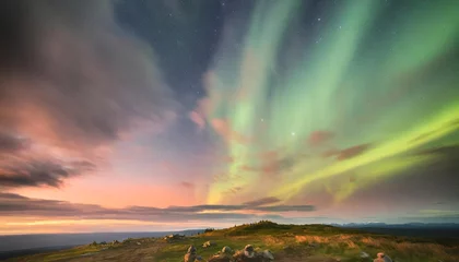 Fototapeten dramatic landscape with beautiful northern lights aurora borealis light show in the sky © Tomas