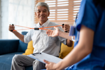 Obraz premium Asian senior elderly man doing physiotherapist with support from nurse. 