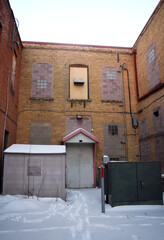 Secluded Area with Brick Buildings Converging in Urban Alleyway During Winter