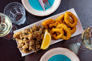 Popular appetizer of Spanish cuisine is squid a la romana and baby andalusian squids served with a...