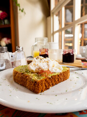 Savory Delight: Guacamole Toasts Topped with Poached Egg and Diced Tomato