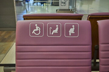 Disabled Handicap sign on a chair reserved for people with disabilities, elderly or pregnant women - obrazy, fototapety, plakaty