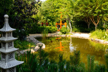 Japanese garden. A pond with a decorative pagoda on the shore.