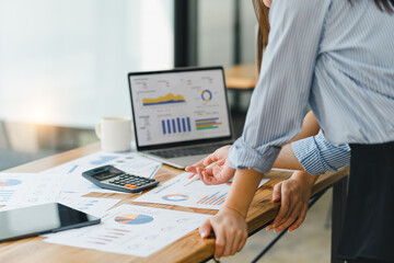 Businesswoman or accountant using laptop to analyze financial investments and business and...