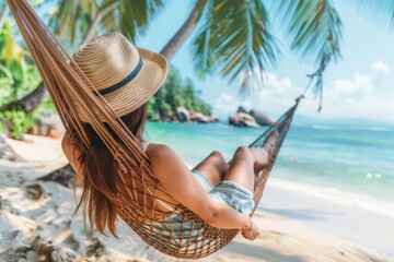 Woman relaxing on beach in hammock under palm