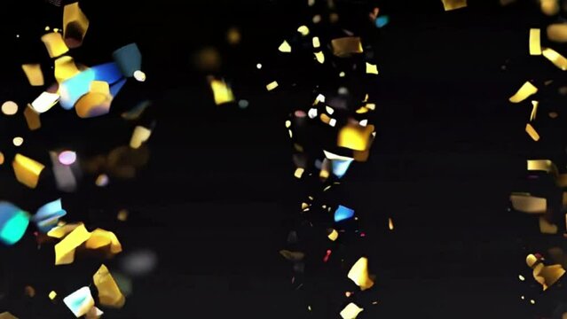 Confetti fired in the air during a party. Only confetti on black background of the night. Falling metallic glitter foil confetti gold in black background