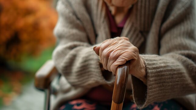 Close up of a senior lady with crutch, elderly lady needing a walking aid or support holding a cane in nursing house, concept of disabled old lady retire life.