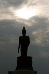 Silhouette of a large Buddha statue with a beautiful sky and clouds in the Phutthamonthon district, Thailand