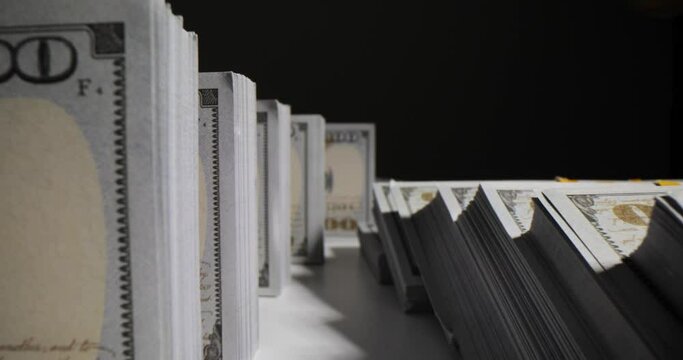 Many packs of dollars on a black background