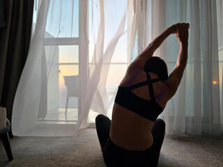 Woman Sitting on Floor in Front of Window