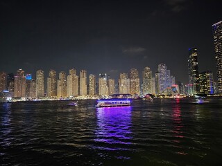 Boat Sailing in City Waters at Night