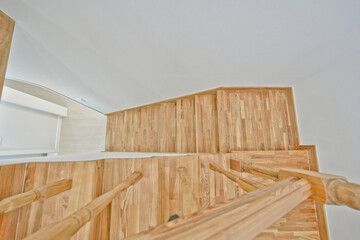 Fototapeta na wymiar Light-colored wooden stairs that match a clean interior