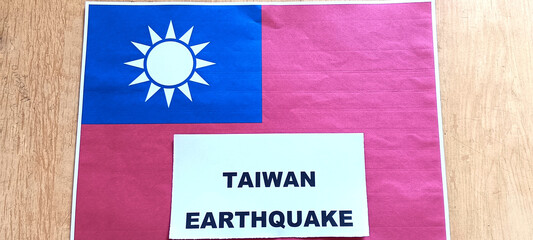 Taiwan earthquake and Taiwan flag printed in paper on the desk.
