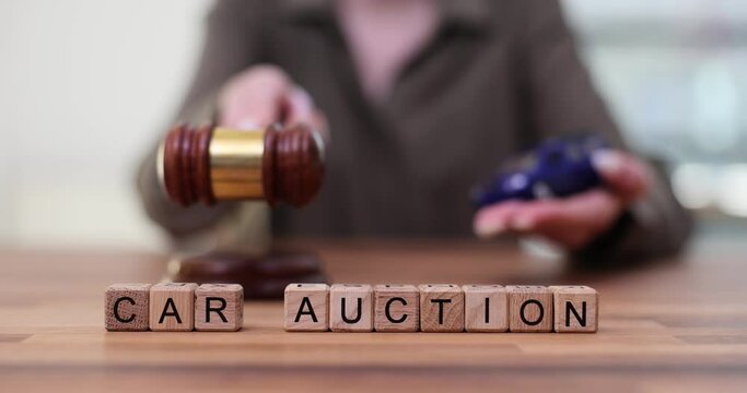 Car auction and car dealer gavel at table