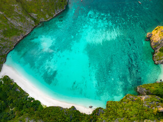 Aerial view of a tropical Maya bay beach with turquoise water and white sand