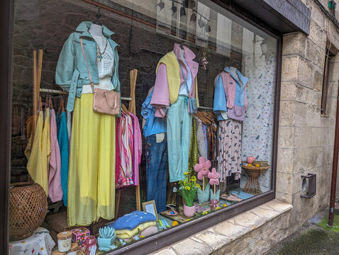 France, 3 March 2024 : Colorful boutique window display with spring fashion collection.
