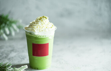 Iced green matcha latte tea and milk in glass on stone table background. Traditional japanese drink  and beverage concept.