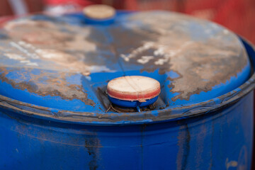 Close-up at chemical liquid drum or barrel bottle cap which is lock seal at the outlet hole....