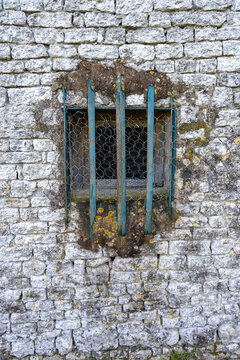 Old Stone Wall with Barred Window
