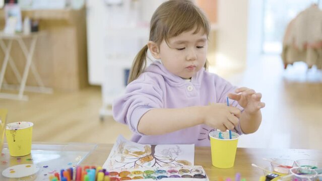 Lovely Young Girl With Watercolor Painting In A Drawing Classroom. Selective Focus Shot