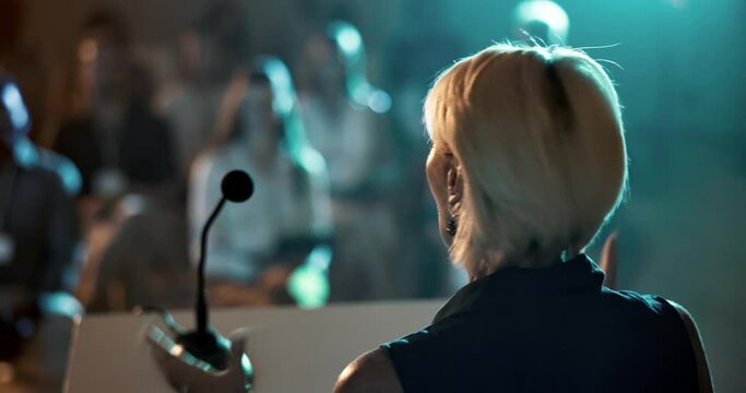 Woman, speaker and podium for audience presentation or seminar for business start up, conference or convention. Female person, back and microphone for international trade show, event or training