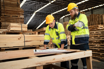 Team Caucasian engineer businessman use paperwork with wood stock background at warehouse	