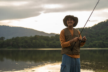 Enjoy moment of Handsome man fishing as a leisure activity during his vacation at the lake on...