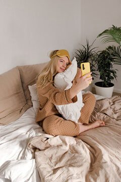 Woman in bed with phone