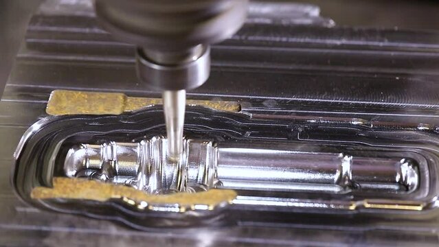 Automated CNC vertical milling machine with face mill endmill tool in process over aluminum metal piece, Industrial Factory coolant liquid on metal component in shaping forming process