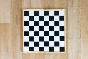 Top view of chess board on wooden background