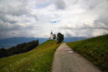 Jamnik, Slovenia - Magical cloudy summer day at Jamnik St.Primoz church. - 775575851