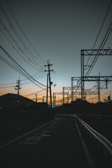 power lines and train at sunset
