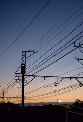 Fototapeta premium power lines and train at sunset