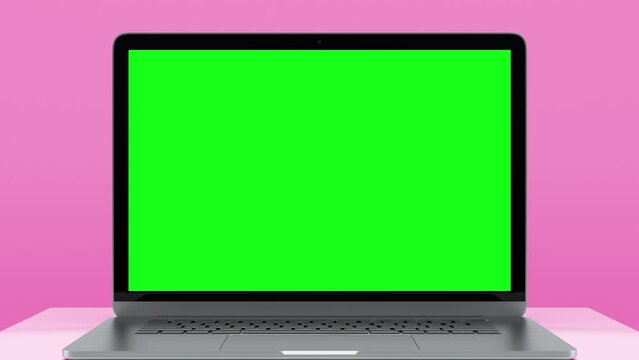 Laptop Computer with Green Screen for Chroma Key. Zoom In on Mock Up of Working PC with Greenscreen for Chromakey on Pink Color Background. Web Presentation of Electronic Object with Horizontal View
