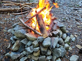 Flames of wood fire in the campground in stone fire pit in the forests of Washington State with a...