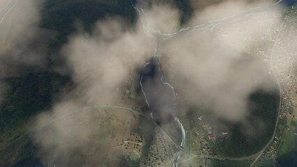 Top aerial view above the clouds of Chemal Dam in Altai Republic. Russia