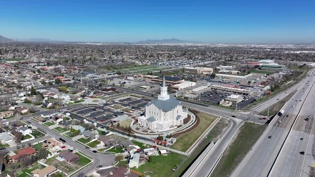 Aerial LDS Taylorsville Utah temple neighbourhood circle fast. The Church of Jesus Christ of Latter-day Saints, LDS or Mormon religion. Fast growing Christian religious sect. Sacred eternal worship.
