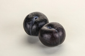 Two ripe sweet black plums