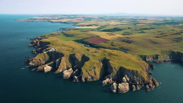 Geographical Wonders Capturing the Essence of Rocky Coastline of St Abbs Head's Cliffs and Lighthouse, Scotland, United Kingdom.