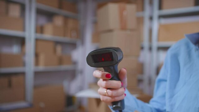 Barcode scanner In the employee's hand close-up