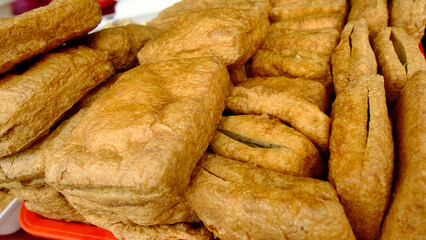 A stack of food items with a red background