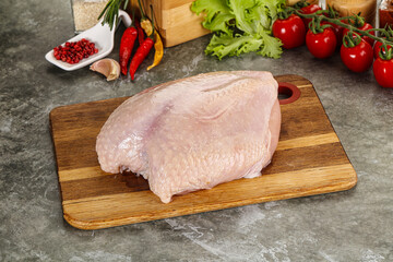 Raw chicken breast with skin