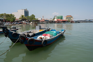 Chew Jetty on Penang in Malaysia is a place with wooden houses on wild constructions and piers in the water