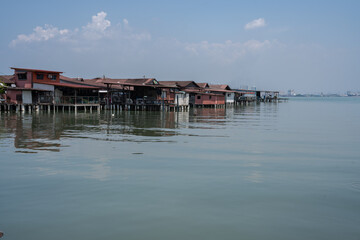 Chew Jetty on Penang in Malaysia is a place with wooden houses on wild constructions and piers in...