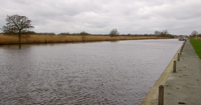 shot looking up the river Bure with moored boat in background