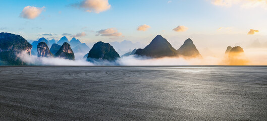 Asphalt road square and beautiful mountains with sky clouds at sunrise. Panoramic view.