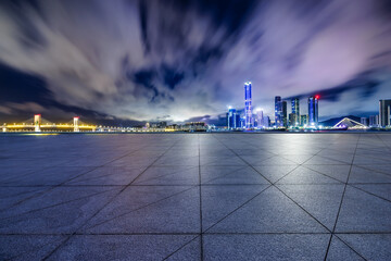 Empty square floors and city skyline with modern buildings scenery at night in Zhuhai