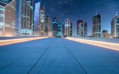 City square floor and modern commercial building scenery at night in Shanghai. Famous financial...